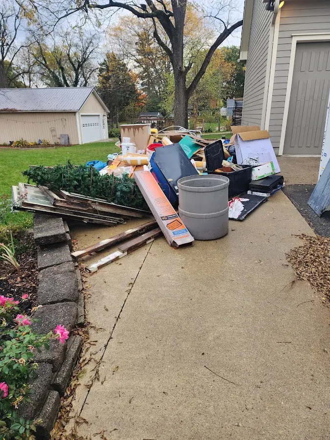 Dumpster being loaded with debris for 3 Yard Dumpster Rental in Irondale